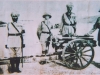 British and Indian Gunners standing beside their gun.